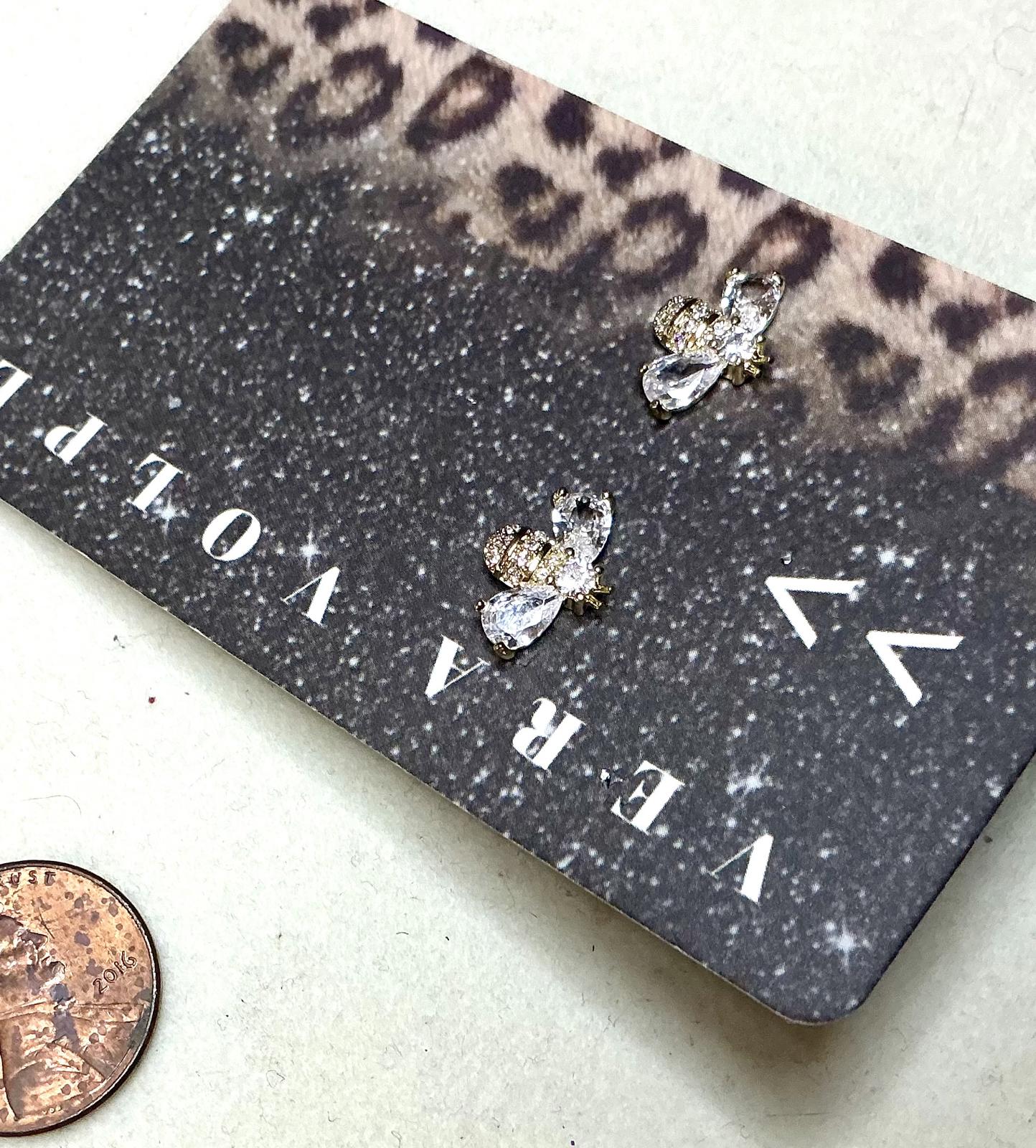 ^ Buzz By Earrings